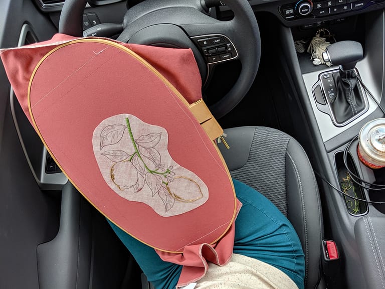 Large embroidery hoop in a car.