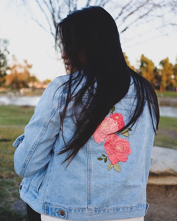 Denim jacket embroidered with floral motif by stitchinginspace